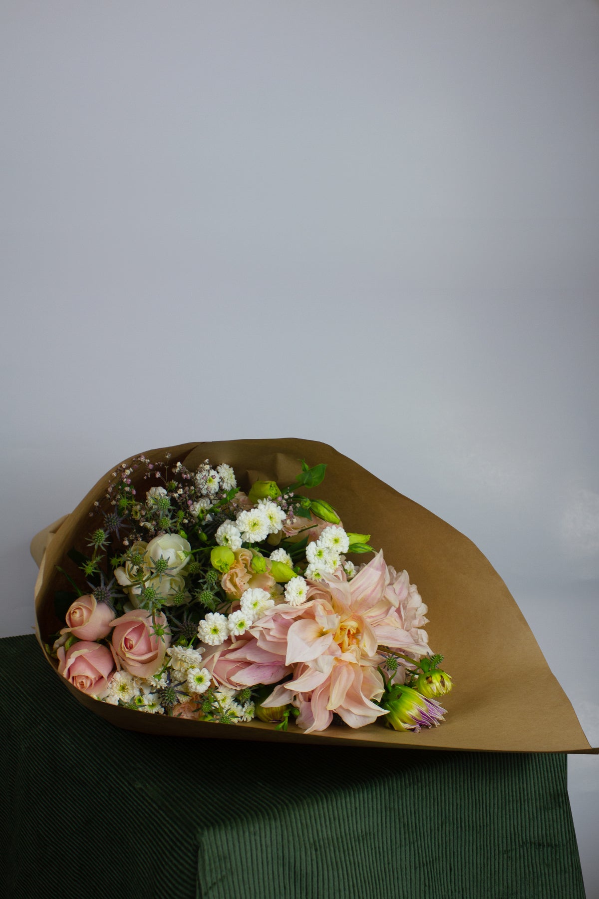 Pastel bouquet wrapped for delivery – soft seasonal colours