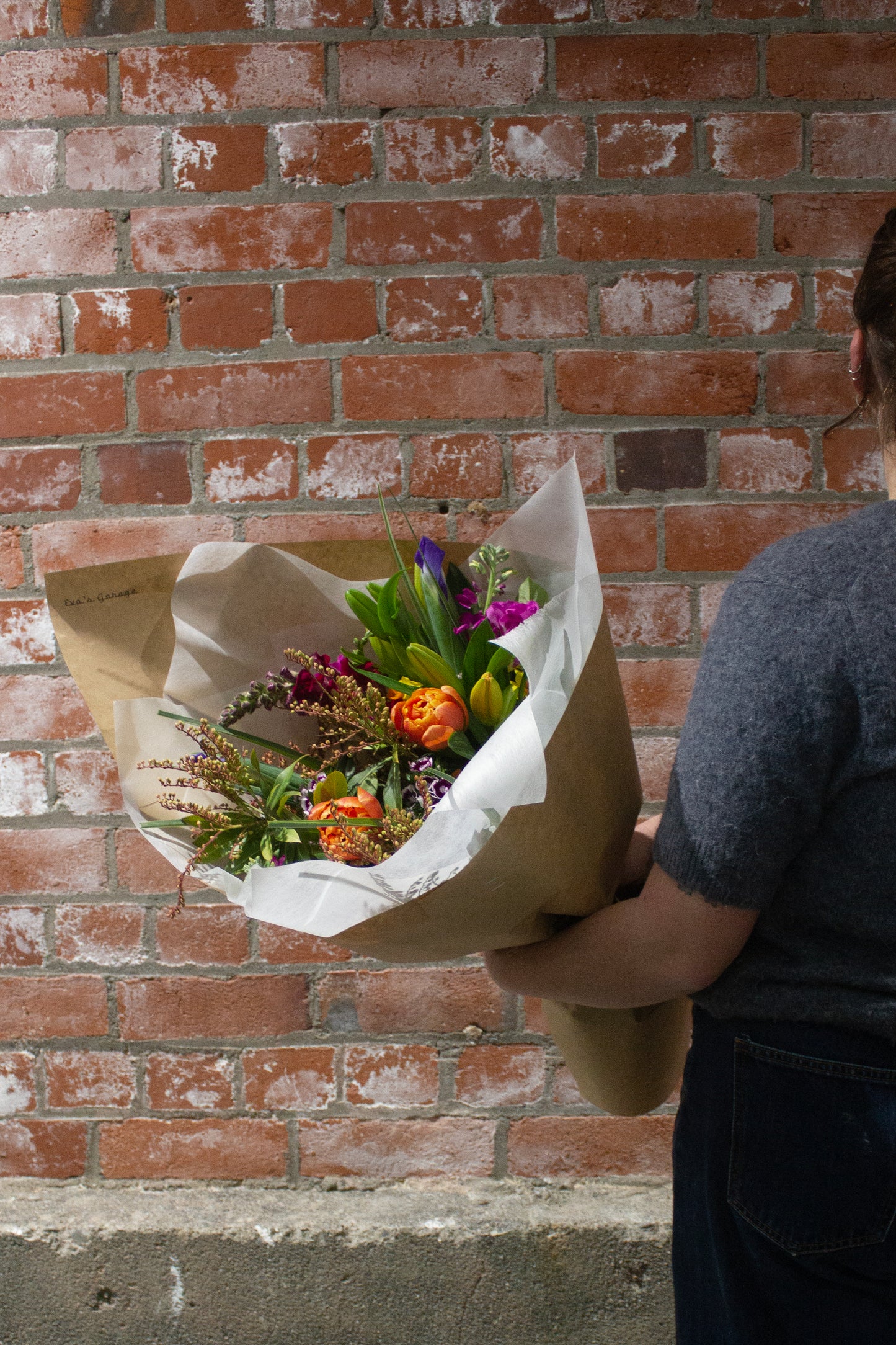 Medium hand-wrapped bouquet with bright seasonal flowers