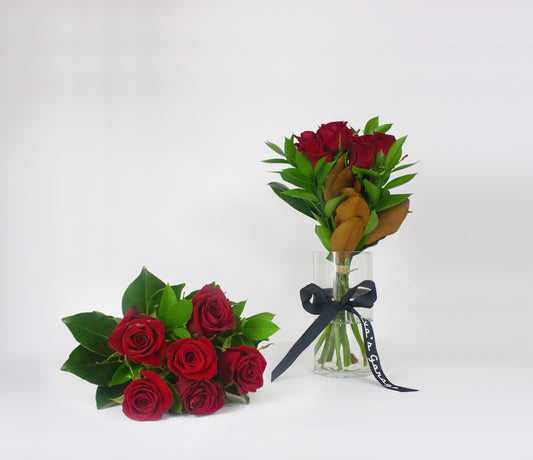 Romantic Bouquets of red roses with green leaves on a white background