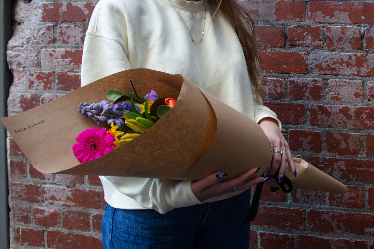 Small wrapped bouquet of fresh bright flowers, delivered locally